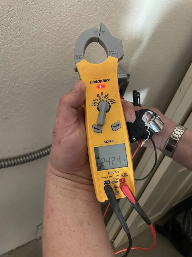 Voltage testing with clamp meter during Electrical Installation Services in St. Johns
